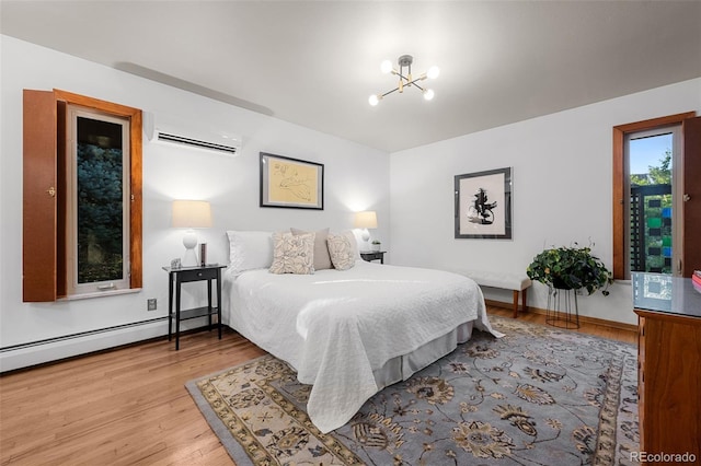 3 Twilight Dr, Wheat Ridge, CO 80215 - bedroom featuring an AC wall unit, a chandelier, and wood finished floors