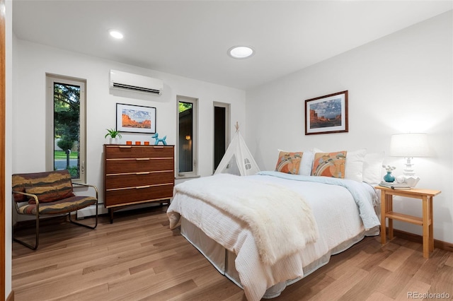3 Twilight Dr, Wheat Ridge, CO 80215 - bedroom featuring a wall unit AC, light wood-style flooring, recessed lighting, and baseboard heating