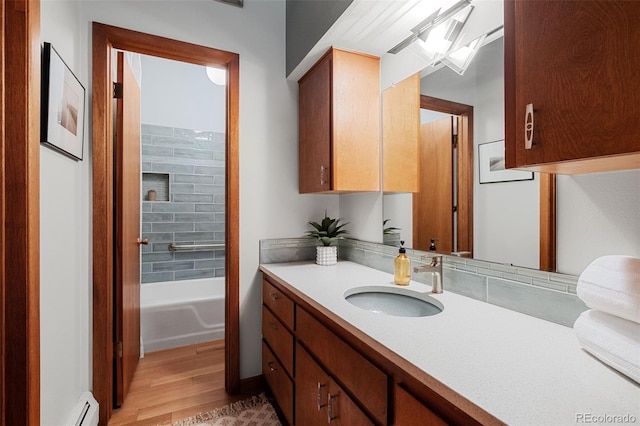 3 Twilight Dr, Wheat Ridge, CO 80215 - full bath with vanity, wood finished floors, and a baseboard heating unit