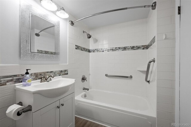 3 Twilight Dr, Wheat Ridge, CO 80215 - bathroom featuring shower / bathtub combination, vanity, wood finished floors, and decorative backsplash