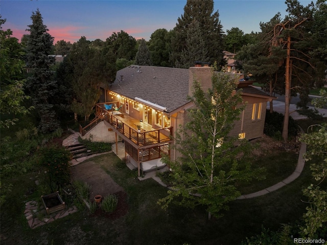 3 Twilight Dr, Wheat Ridge, CO 80215 - back of property at dusk featuring a deck, a chimney, a shingled roof, and stairway