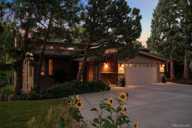 3 Twilight Dr, Wheat Ridge, CO 80215 - view of front facade with concrete driveway, an attached garage, brick siding, a yard, and stone siding