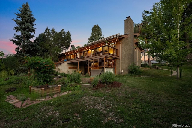 3 Twilight Dr, Wheat Ridge, CO 80215 - rear view of house featuring a lawn, a garden, a wooden deck, and a chimney