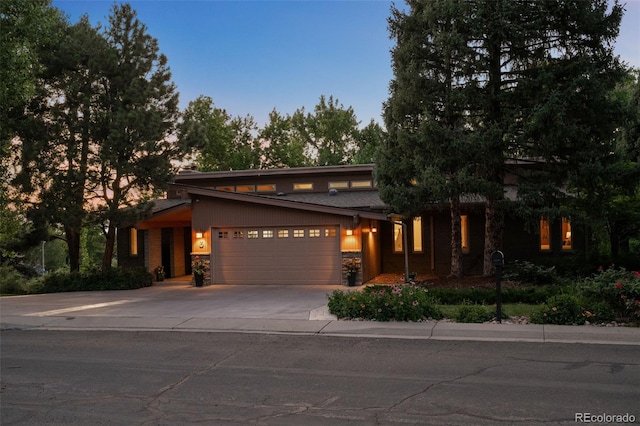 3 Twilight Dr, Wheat Ridge, CO 80215 - view of front of home featuring an attached garage, driveway, and stone siding