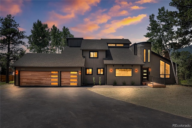 2289 Hiwan Dr, Evergreen, CO 80439 - view of front facade featuring asphalt driveway, a shingled roof, and a garage