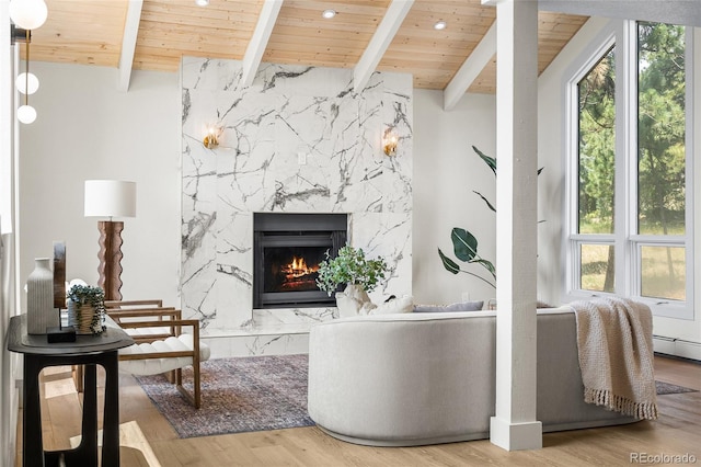 2289 Hiwan Dr, Evergreen, CO 80439 - living area with a wood ceiling with exposed beams, a high end fireplace, and wood finished floors