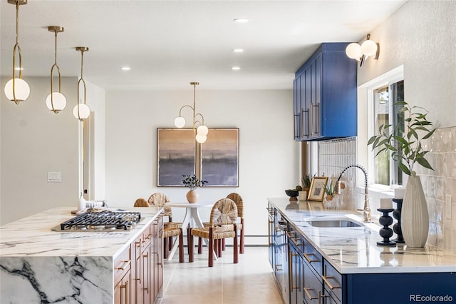 2289 Hiwan Dr, Evergreen, CO 80439 - kitchen featuring blue cabinets, light stone countertops, recessed lighting, pendant lighting, and stainless steel gas cooktop