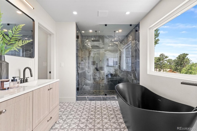 2289 Hiwan Dr, Evergreen, CO 80439 - bathroom featuring a marble finish shower, vanity, a soaking tub, recessed lighting, and tile patterned flooring