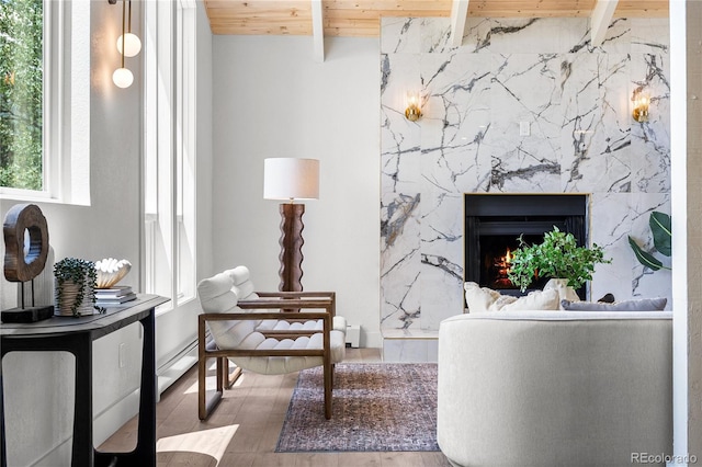 2289 Hiwan Dr, Evergreen, CO 80439 - living room featuring a wooden ceiling with exposed beams, a fireplace, and wood finished floors