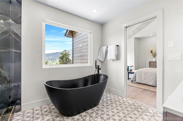 2289 Hiwan Dr, Evergreen, CO 80439 - ensuite bathroom featuring a freestanding bath, tile patterned floors, and a shower with shower door
