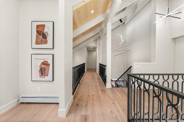 2289 Hiwan Dr, Evergreen, CO 80439 - hallway with a baseboard heating unit, an upstairs landing, light wood-type flooring, wooden ceiling, and recessed lighting