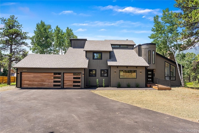 2289 Hiwan Dr, Evergreen, CO 80439 - view of front of property featuring asphalt driveway, an attached garage, and roof with shingles