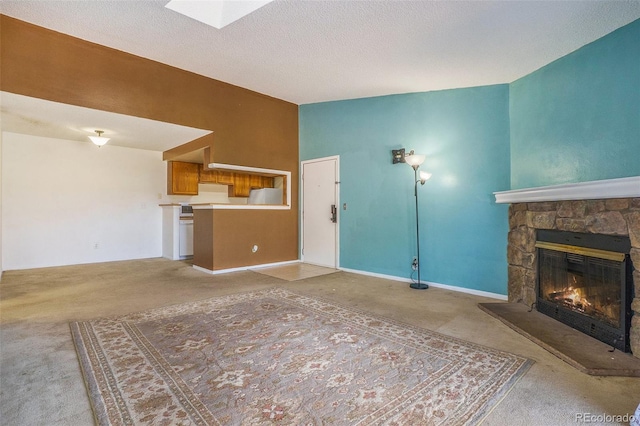 unfurnished living room with a fireplace, light colored carpet, and a textured ceiling
