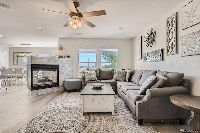 6187 Wescroft Ave, Castle Rock, CO 80104 - living area with wood finished floors, ceiling fan, recessed lighting, and a multi sided fireplace