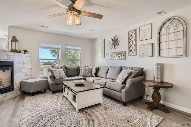 6187 Wescroft Ave, Castle Rock, CO 80104 - living room with wood finished floors, a fireplace, a ceiling fan, and baseboards