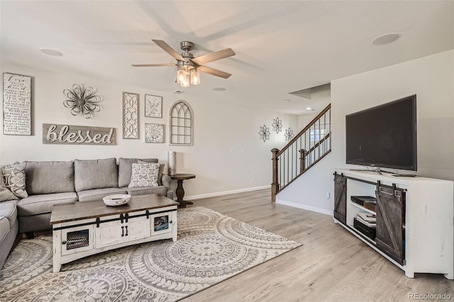 6187 Wescroft Ave, Castle Rock, CO 80104 - living room featuring light wood-style floors, a ceiling fan, stairs, and baseboards