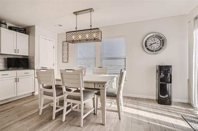 6187 Wescroft Ave, Castle Rock, CO 80104 - dining room with light wood-style flooring and baseboards