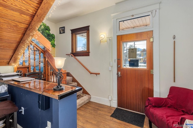 entrance foyer with wood-type flooring, lofted ceiling, and wood ceiling