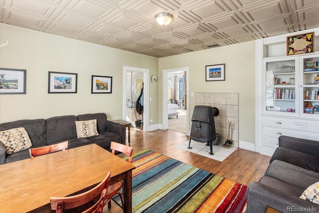 living room with a wood stove and light hardwood / wood-style floors