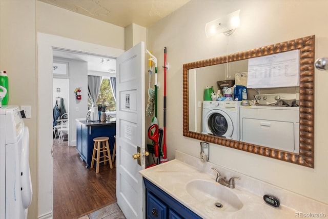 bathroom featuring hardwood / wood-style flooring, vanity, and independent washer and dryer