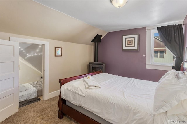 bedroom featuring lofted ceiling, a wood stove, and light carpet