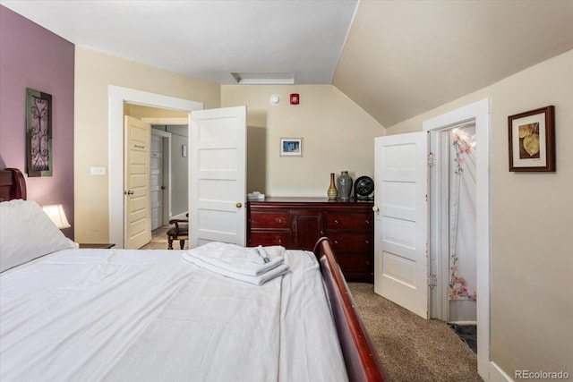 carpeted bedroom with lofted ceiling