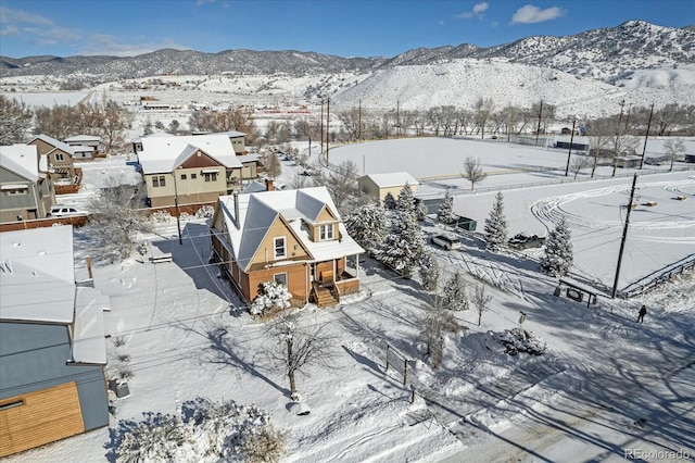 snowy aerial view with a mountain view