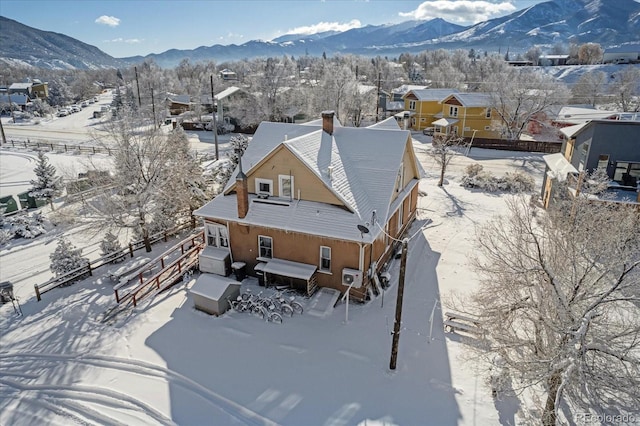 snowy aerial view featuring a mountain view