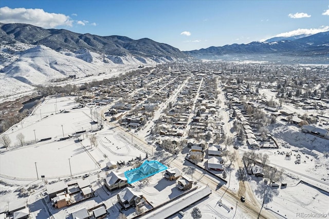 snowy aerial view featuring a mountain view