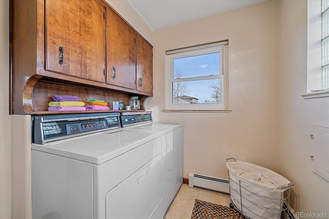 clothes washing area with cabinets, a baseboard radiator, washer and clothes dryer, and light tile patterned flooring