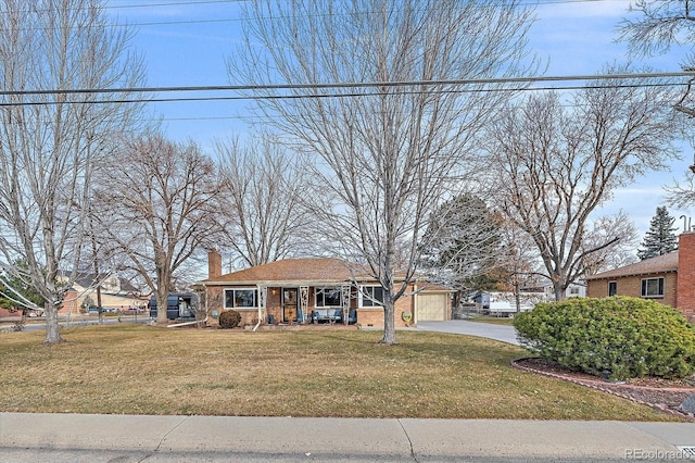 view of front of property with a garage, covered porch, and a front lawn