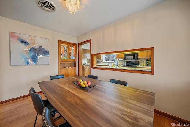 dining area with light hardwood / wood-style flooring