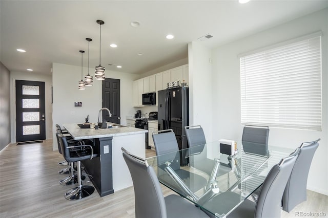 26985 E Bayaud Ave, Aurora, CO 80018 - dining space featuring light wood-style flooring, recessed lighting, plenty of natural light, and baseboards