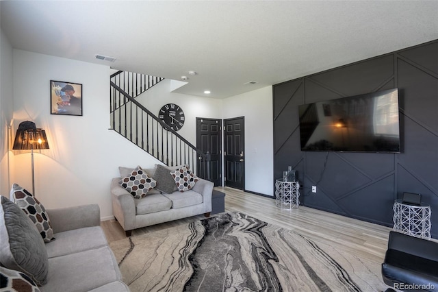 26985 E Bayaud Ave, Aurora, CO 80018 - living area with stairway, light wood finished floors, and baseboards