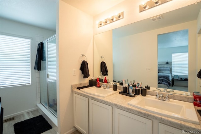 26985 E Bayaud Ave, Aurora, CO 80018 - bathroom with connected bathroom, double vanity, and a stall shower