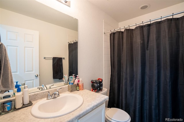 26985 E Bayaud Ave, Aurora, CO 80018 - full bathroom with vanity, toilet, and a shower with shower curtain
