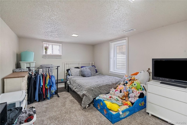 carpeted bedroom with a textured ceiling