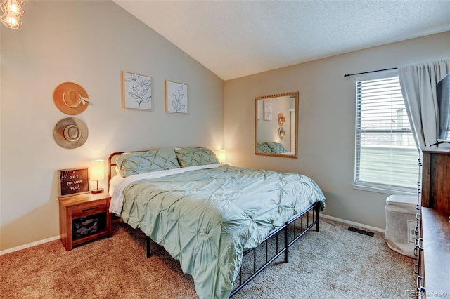 bedroom featuring carpet flooring, baseboards, visible vents, and lofted ceiling
