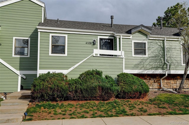 view of front of home with a shingled roof