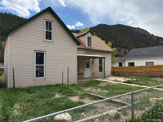 219 Colorado Blvd, Idaho Springs, CO 80452 - back of property featuring a mountain view, a fenced backyard, and a patio area