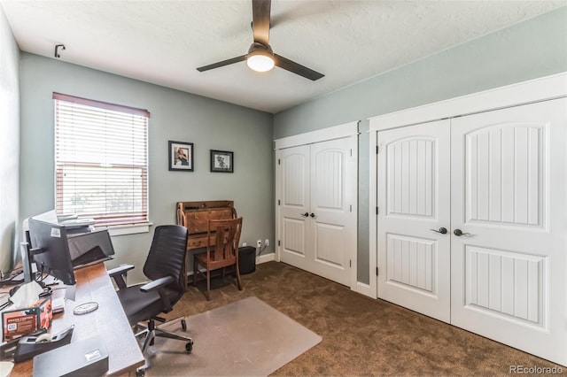 office area with carpet flooring, baseboards, and ceiling fan