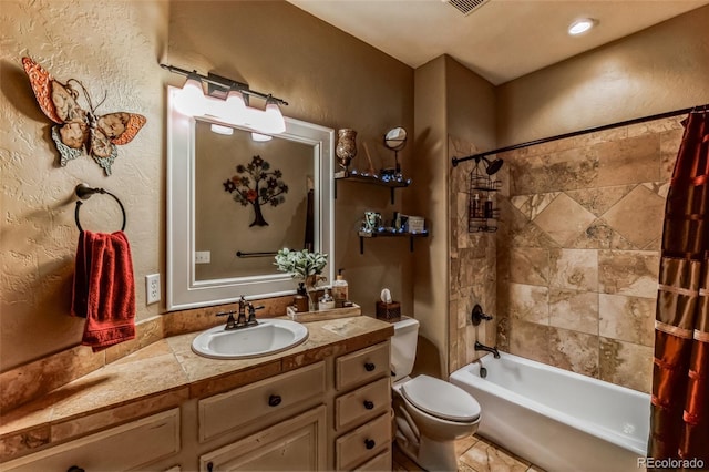 bathroom with shower / bath combo with shower curtain, toilet, vanity, and a textured wall