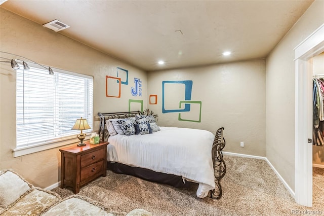 carpeted bedroom with recessed lighting, baseboards, and visible vents