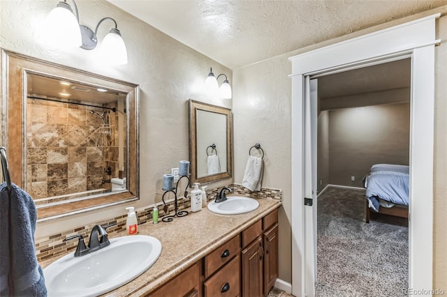 full bathroom with a sink, a textured ceiling, double vanity, and a textured wall