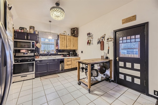 kitchen with light brown cabinets, stainless steel appliances, tasteful backsplash, sink, and light tile patterned floors