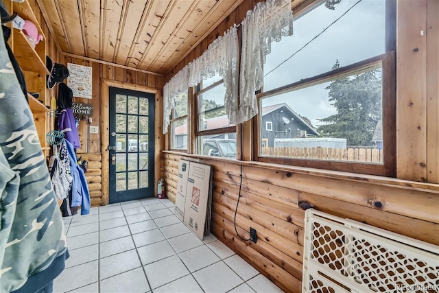 interior space with wooden walls, light tile patterned floors, log walls, and wood ceiling