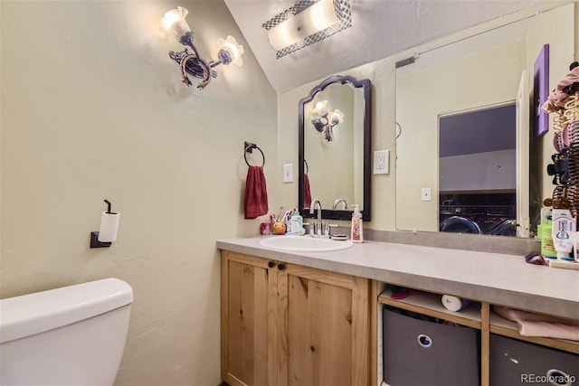 bathroom featuring vanity, vaulted ceiling, and toilet