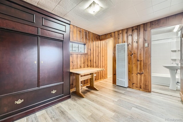 office space with sink and light wood-type flooring