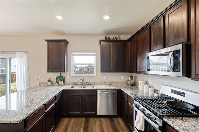 7232 Shavano Ave, Frederick, CO 80504 - kitchen featuring appliances with stainless steel finishes, a sink, healthy amount of natural light, dark brown cabinets, and recessed lighting
