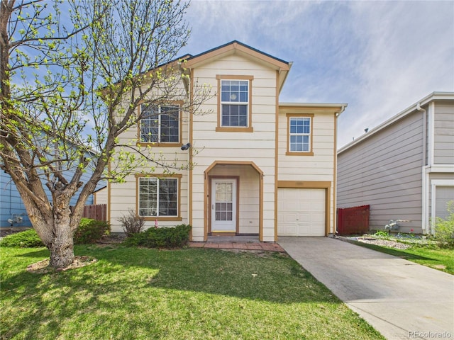 traditional home featuring a front lawn, an attached garage, and concrete driveway